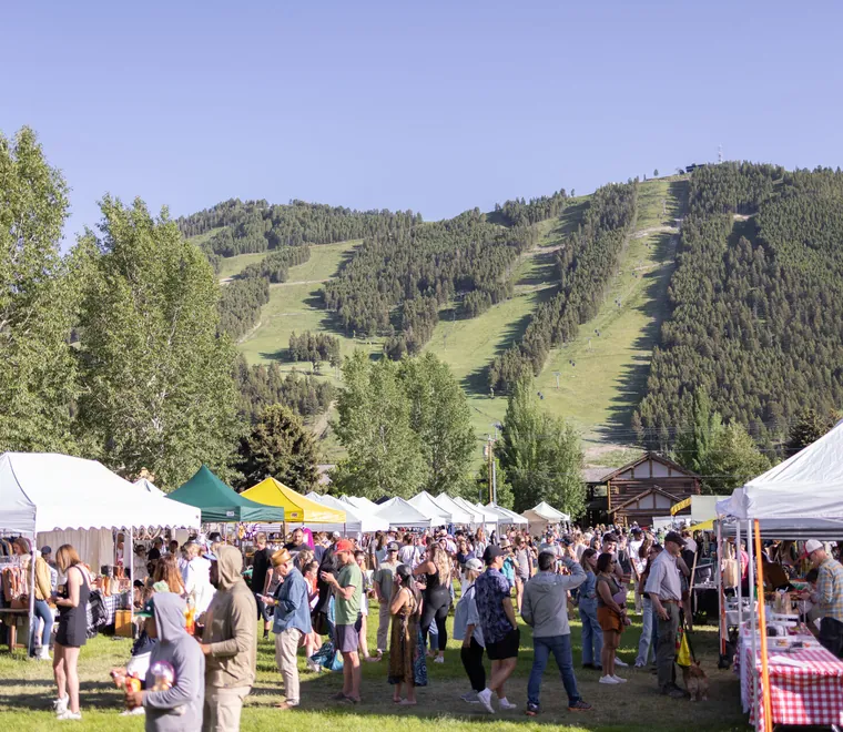 Festival tents on the lawn below the Snow King ski runs in summer