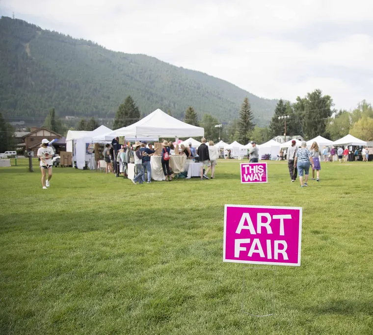 Art fair tents on a park lawn