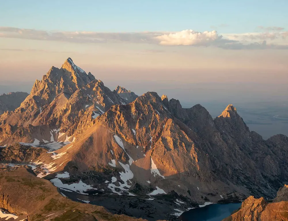 The Grand Teton summit ridge in warm alpenglow